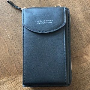 Crossbody clutch wallet holds phone, cards, cash.